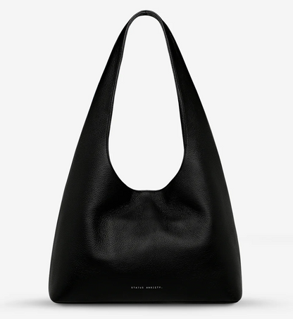 Solstice Bag - Black - Status Anxiety 

Relaxed yet reliable, 'Solstice' is a slouchy tote that carries more than it lets on (including a 13-inch laptop). Soft, spacious, and closed with the snap of a magnet, 'Solstice' is unstructured and easygoing in all the right ways.

Soft shrunken pebble leather
Internal zipper pocket, lipstick pocket, and open pouch pocket
Fits a 13-inch laptop
Magnet closure
Custom Status Anxiety lining
Comes in a Status Anxiety branded drawstring bag