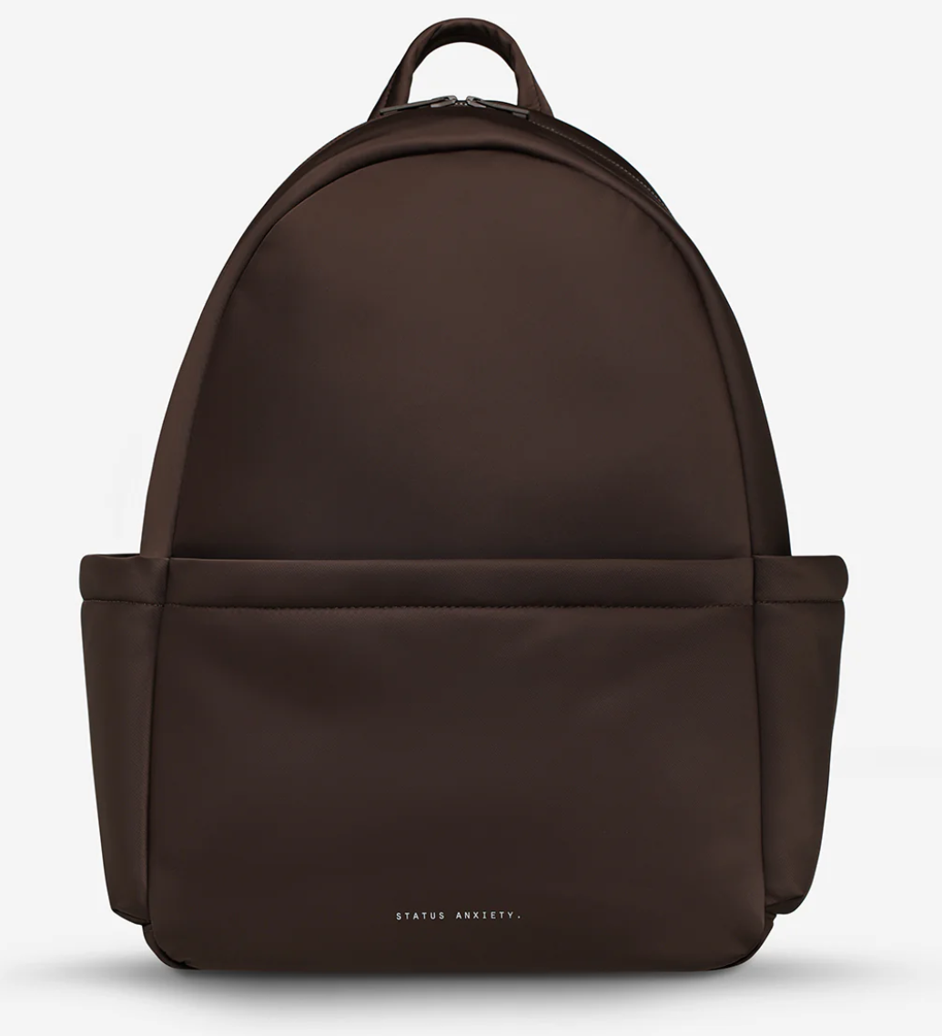 Frankie Recycled Bag - Truffle - Status Anxiety 

Tough, functional and lightweight – just what you've been looking for in a backpack (plus not to mention obvious good looks). Multiple exterior pockets keep everything within reach, while its lightweight build makes it ready for workdays, weekends, and everything between.

Premium reinforced recycled polyester (otherwise destined for landfill)
Back sleeve for sliding onto your suitcase
Dual external side pockets, and front zipper pocket
Internal open pockets