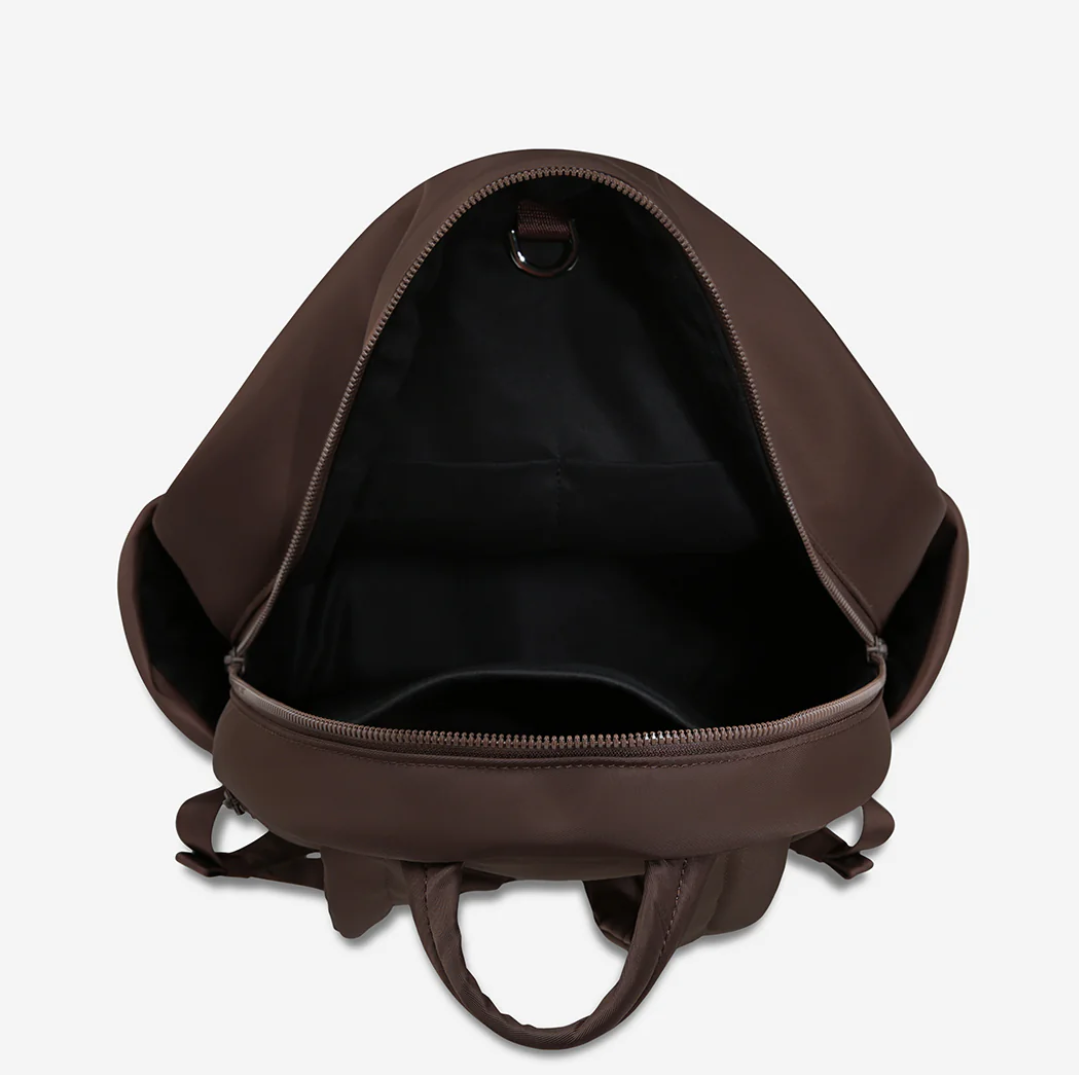 Frankie Recycled Bag - Truffle - Status Anxiety 

Tough, functional and lightweight – just what you've been looking for in a backpack (plus not to mention obvious good looks). Multiple exterior pockets keep everything within reach, while its lightweight build makes it ready for workdays, weekends, and everything between.

Premium reinforced recycled polyester (otherwise destined for landfill)
Back sleeve for sliding onto your suitcase
Dual external side pockets, and front zipper pocket
Internal open pockets