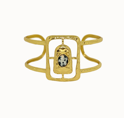 Astrid Gold Cuff - Mountain & Moon 

Description

Astrid commands attention without asking for it. A wide hammered gold cuff with an open rectangular frame at its centre, set with a Dalmatian Jasper stone - architectural, organic, and unmistakably considered.

A statement piece from the Odyssey collection - for the woman who adorns herself with meaning, not just habit.

Micron 18K gold & sterling silver plating 
to premium jewellery standards