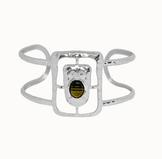 Astrid Cuff Silver - Mountain & Moon 

Description
The Astrid Cuff in silver brings a more elevated, more directional energy. An open rectangular frame - in cool silver with a Tigers Eye stone at the centre, its warm amber tones creating a striking contrast against the polished metal.
Part of the Odyssey collection - for the woman in motion, who dresses with instinct.

Micron 18K gold & sterling silver plating 
to premium jewellery standards