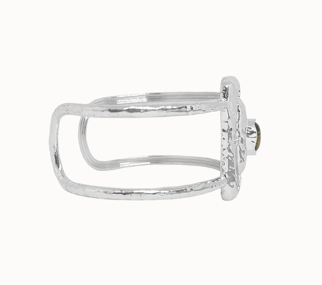 Astrid Cuff Silver - Mountain & Moon 

Description
The Astrid Cuff in silver brings a more elevated, more directional energy. An open rectangular frame - in cool silver with a Tigers Eye stone at the centre, its warm amber tones creating a striking contrast against the polished metal.
Part of the Odyssey collection - for the woman in motion, who dresses with instinct.

Micron 18K gold & sterling silver plating 
to premium jewellery standards