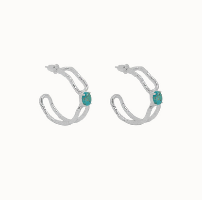 Sascha Earrings Silver - Mountain & Moon 

Description

ELEVATED ESSENTIALS • WEAR ON REPEAT

The Sascha Earrings bring sculptural sophistication to your everyday rotation. 
An organic, open double-hoop silhouette anchored by a vibrant Blue Mojave Turquoise gemstone at its centre - an unexpected focal point that feels both grounded and playful. Softly textured silver catches the light, adding dimension and a subtle vintage-inspired edge.