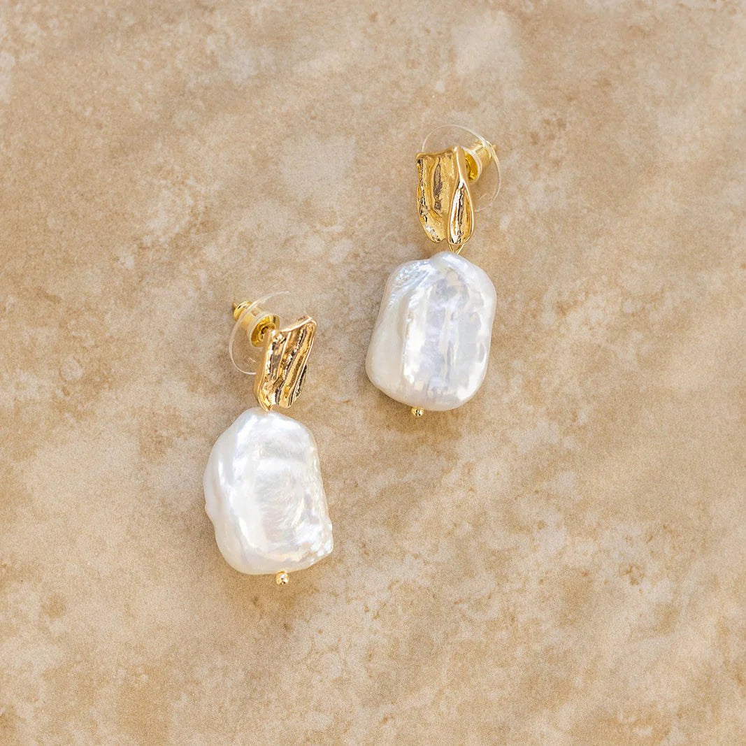 Our NOA earrings are a must have masterpiece, showcasing nature's purest pearls. The perfect pair of earrings for a boho bride!

S925 Gold Plated Sterling Silver
Baroque Pearl/Drop Earrings
Lead,Nickel &amp; Tarnish Free
Hypoallergenic
Varies between 3-4cm