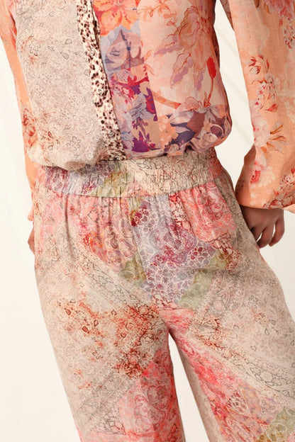 the kachel selena pant in pink is a stylish wide-leg pant in a viscose fabric in a beaituful patchwork print in warm feminine tones