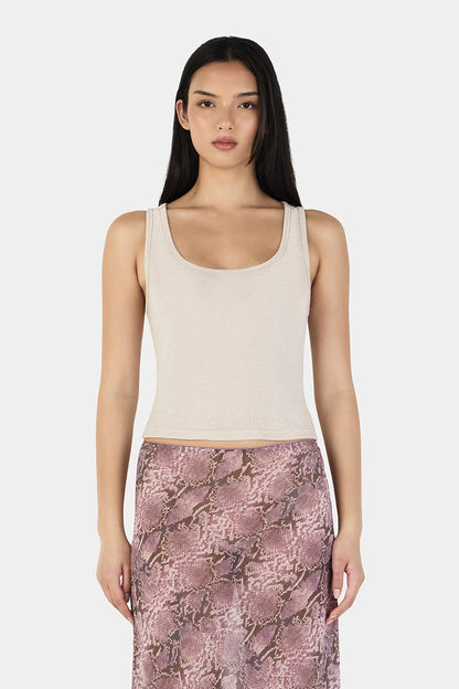 The Solstice Tank in Cream by OWNLEY is a fitted racerback tank top crafted from a soft lurex knit with a subtle shimmer. Designed with a low scooped neckline and clean, minimal finish, it contours smoothly through the body for a flattering silhouette.