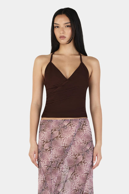 The Erin Top in Chocolate by OWNLEY is a cami top silhouette. Designed in a flattering wrap silhouette, it features light gathering at the side seams, with a twist rope inspired straps. The backless design adds a striking finish, while the front is fully self-lined for support and coverage.
