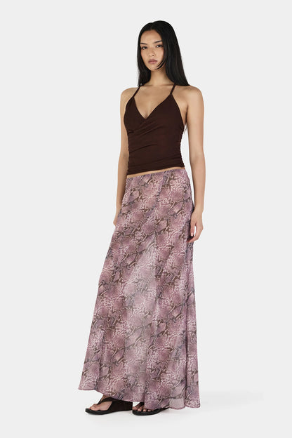 The Erin Top in Chocolate by OWNLEY is a cami top silhouette. Designed in a flattering wrap silhouette, it features light gathering at the side seams, with a twist rope inspired straps. The backless design adds a striking finish, while the front is fully self-lined for support and coverage.