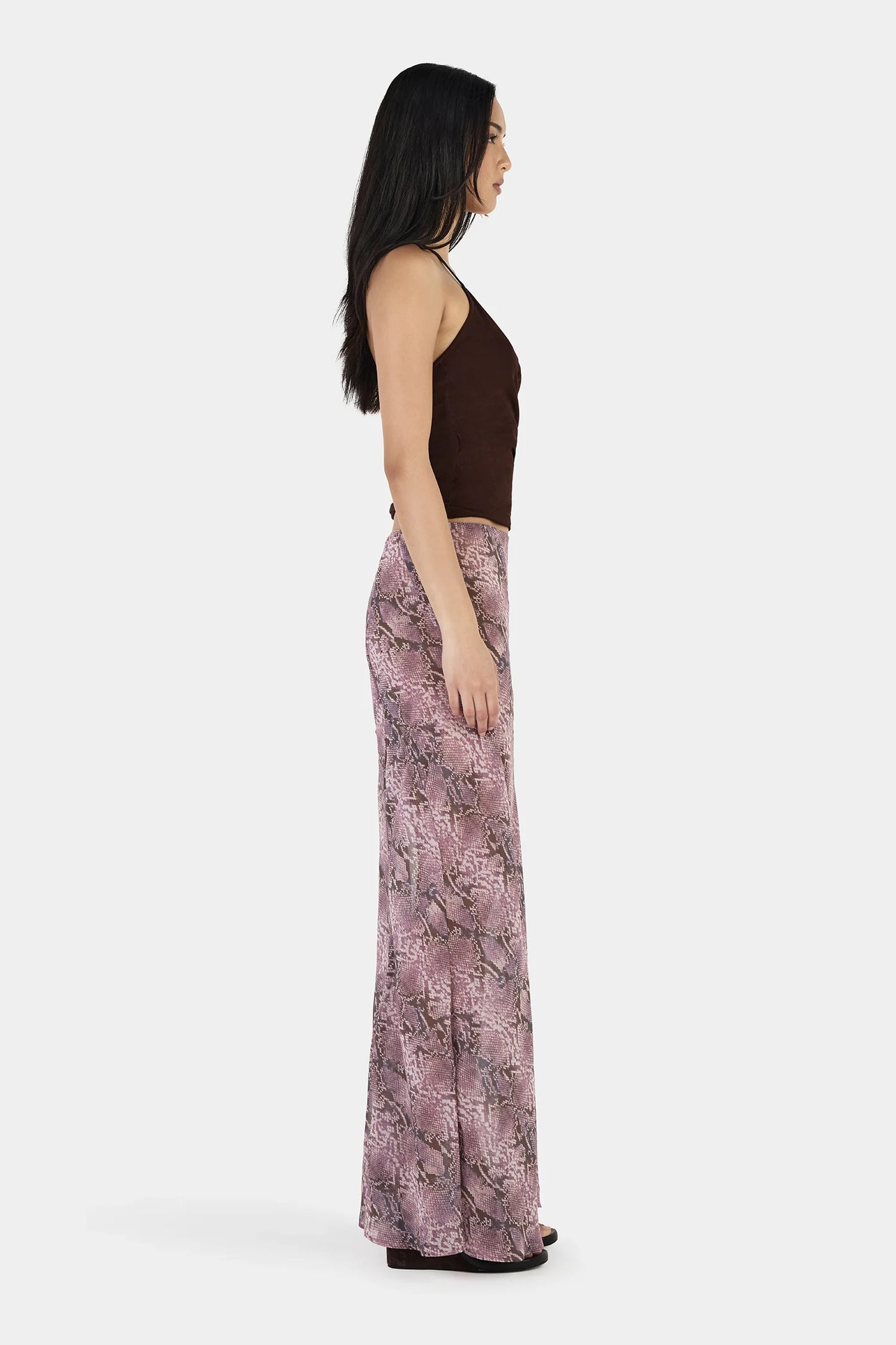 The Erin Top in Chocolate by OWNLEY is a cami top silhouette. Designed in a flattering wrap silhouette, it features light gathering at the side seams, with a twist rope inspired straps. The backless design adds a striking finish, while the front is fully self-lined for support and coverage.