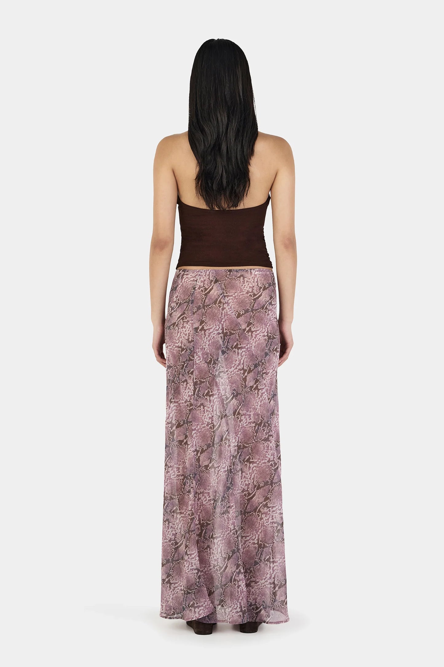 The Erin Top in Chocolate by OWNLEY is a cami top silhouette. Designed in a flattering wrap silhouette, it features light gathering at the side seams, with a twist rope inspired straps. The backless design adds a striking finish, while the front is fully self-lined for support and coverage.