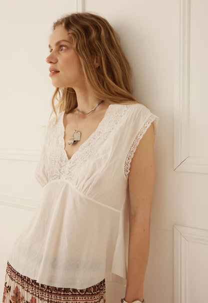 The Bridget Lace Cami by SPELL, in Pearl exudes effortless femininity with a romantic, vintage-inspired spirit. Timeless with a modern twist, this beautifully considered silhouette combines delicate detailing with a flattering, body-skimming shape.

Crafted from 100% organic cotton, it offers a soft, breathable feel with a natural texture that makes it perfect for everyday wear. A flattering V-neckline is framed by delicate lace trim along the neck and armholes, while the underbust panel with soft gathers a