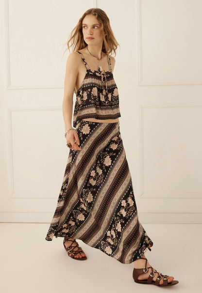 The Petalwood Maxi Skirt in Nightfall by SPELL, exudes effortless romance with a free-spirited, vintage-inspired spirit. Timeless with a modern twist, this flowing silhouette captures the beauty of the Petalwood print through fluid movement and an effortlessly flattering shape.

Crafted from 100% LENZING™ ECOVERO™ Viscose, it offers a lightweight, fluid feel with a beautiful drape that moves gracefully with the body. The bias-cut construction skims the silhouette, while the elastic waist provides an easy, c