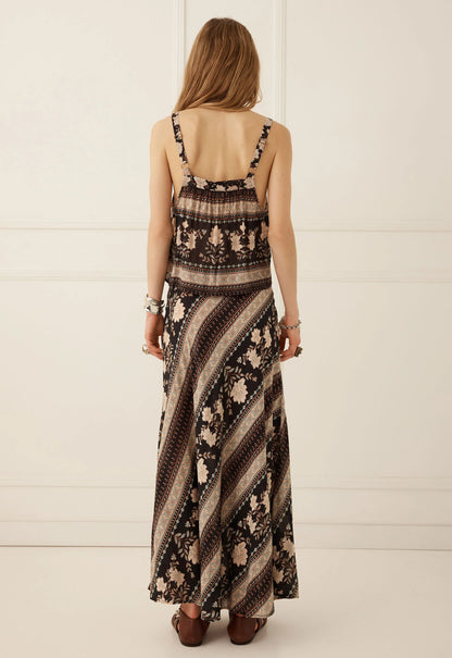 The Petalwood Maxi Skirt in Nightfall by SPELL, exudes effortless romance with a free-spirited, vintage-inspired spirit. Timeless with a modern twist, this flowing silhouette captures the beauty of the Petalwood print through fluid movement and an effortlessly flattering shape.

Crafted from 100% LENZING™ ECOVERO™ Viscose, it offers a lightweight, fluid feel with a beautiful drape that moves gracefully with the body. The bias-cut construction skims the silhouette, while the elastic waist provides an easy, c