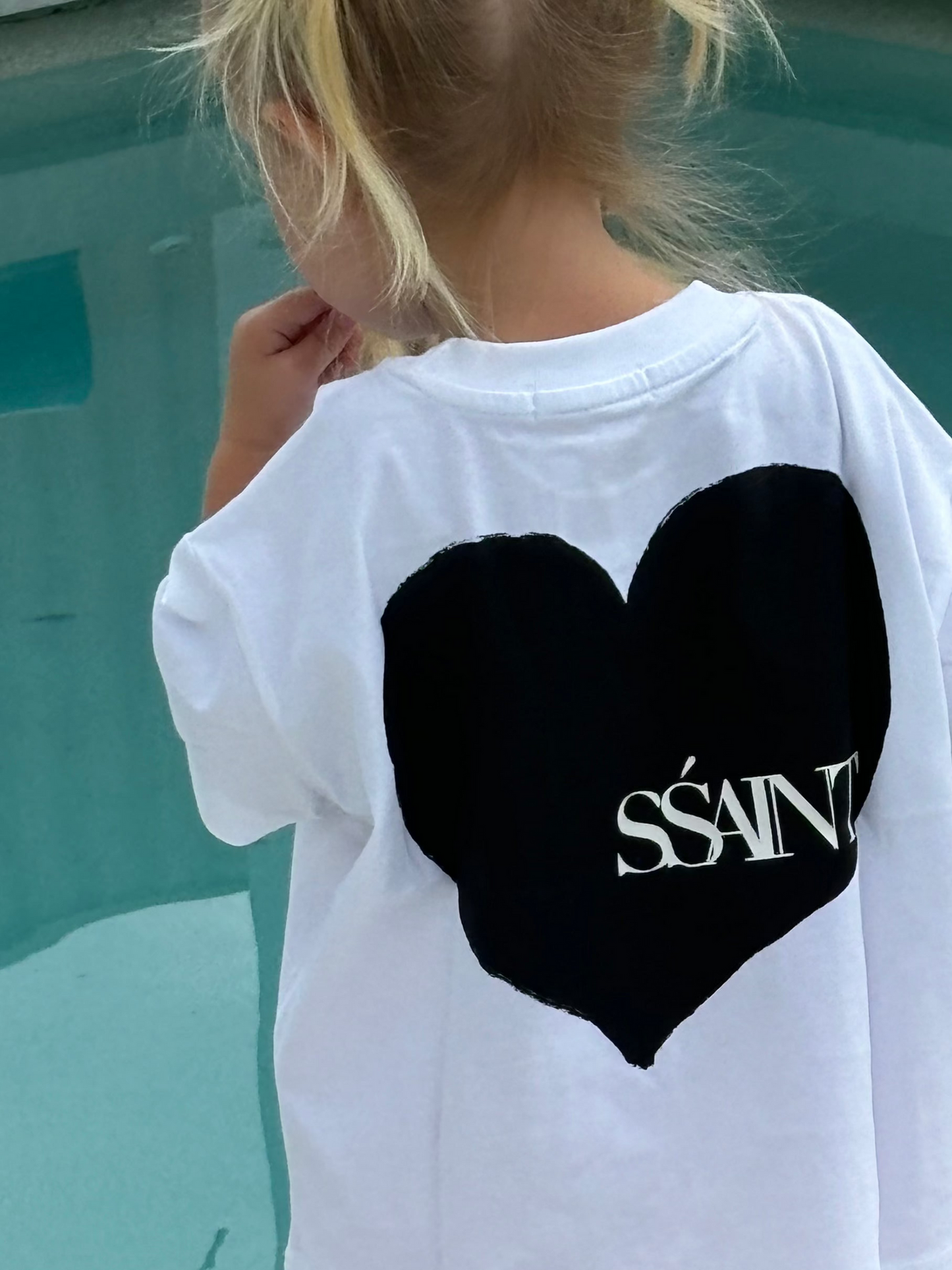 Introducing the Kids' SŚAINT Heart T-Shirt
A little heart on the front, a whole lot of love on the back. This unisex tee is perfect for the little lovers of the world. Made from 100% cotton with a relaxed fit, it’s designed for effortless comfort and style. Match with your mini and pair it back with our SŚAINT Heart Tee for a coordinated look that’s full of love.