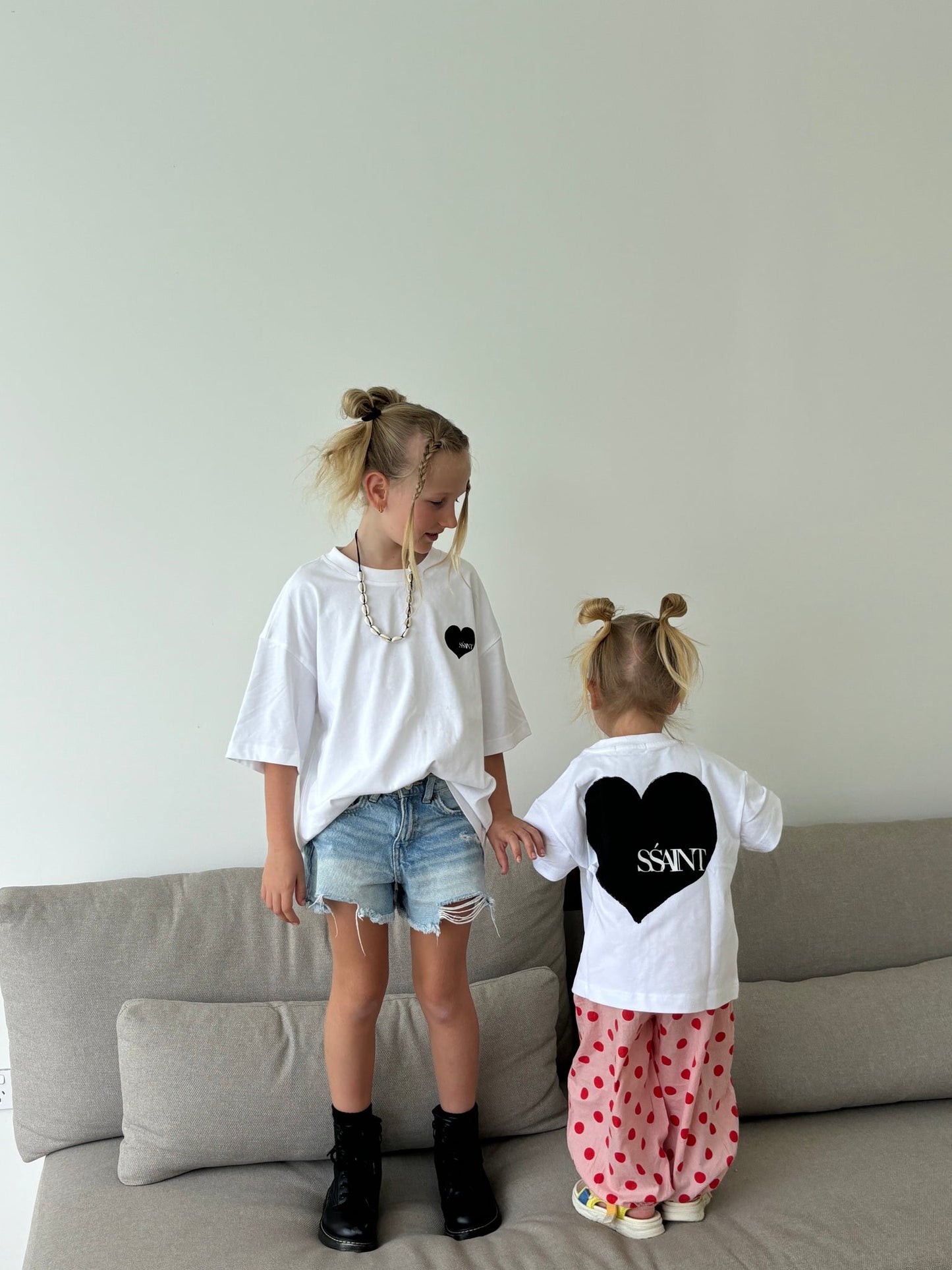 Introducing the Kids' SŚAINT Heart T-Shirt
A little heart on the front, a whole lot of love on the back. This unisex tee is perfect for the little lovers of the world. Made from 100% cotton with a relaxed fit, it’s designed for effortless comfort and style. Match with your mini and pair it back with our SŚAINT Heart Tee for a coordinated look that’s full of love.