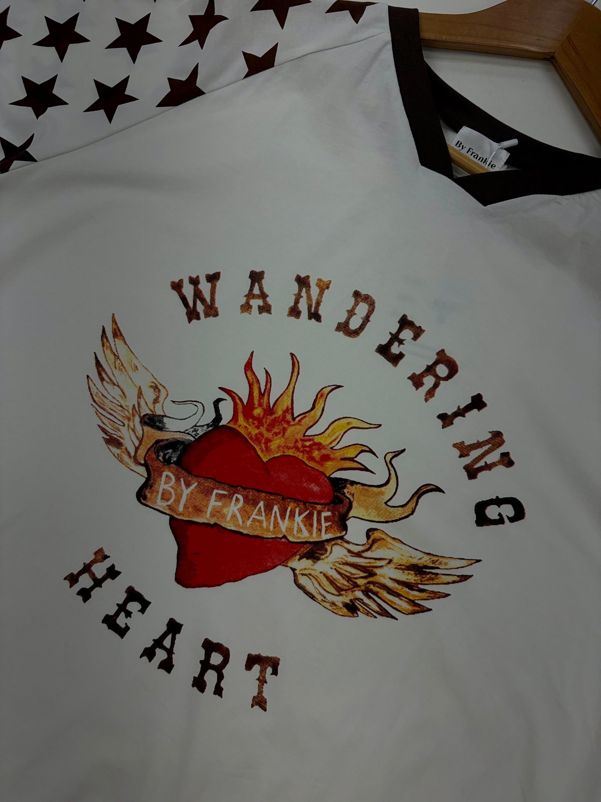 Wandering Heart Tee -By Frankie

Crafted for comfort and style, this gorgeous tee features a classic ribbed crew neckline, mid-length sleeves, and a relaxed fit — perfect for layering or wearing on its own. The soft fabric drapes beautifully, while the star print detailing on the sleeves adds a fun, laid-back touch.

Fun, playful, and full of personality — this is an easy go-to for any season

FEATURES
Original painted image
Item is oversized, if you would like a tighter fit, size down