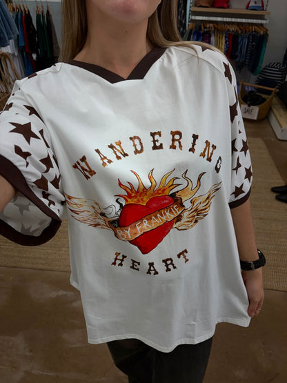 Wandering Heart Tee -By Frankie

Crafted for comfort and style, this gorgeous tee features a classic ribbed crew neckline, mid-length sleeves, and a relaxed fit — perfect for layering or wearing on its own. The soft fabric drapes beautifully, while the star print detailing on the sleeves adds a fun, laid-back touch.

Fun, playful, and full of personality — this is an easy go-to for any season

FEATURES
Original painted image
Item is oversized, if you would like a tighter fit, size down