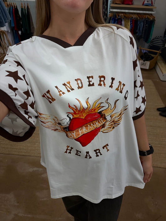 Wandering Heart Tee -By Frankie

Crafted for comfort and style, this gorgeous tee features a classic ribbed crew neckline, mid-length sleeves, and a relaxed fit — perfect for layering or wearing on its own. The soft fabric drapes beautifully, while the star print detailing on the sleeves adds a fun, laid-back touch.

Fun, playful, and full of personality — this is an easy go-to for any season

FEATURES
Original painted image
Item is oversized, if you would like a tighter fit, size down