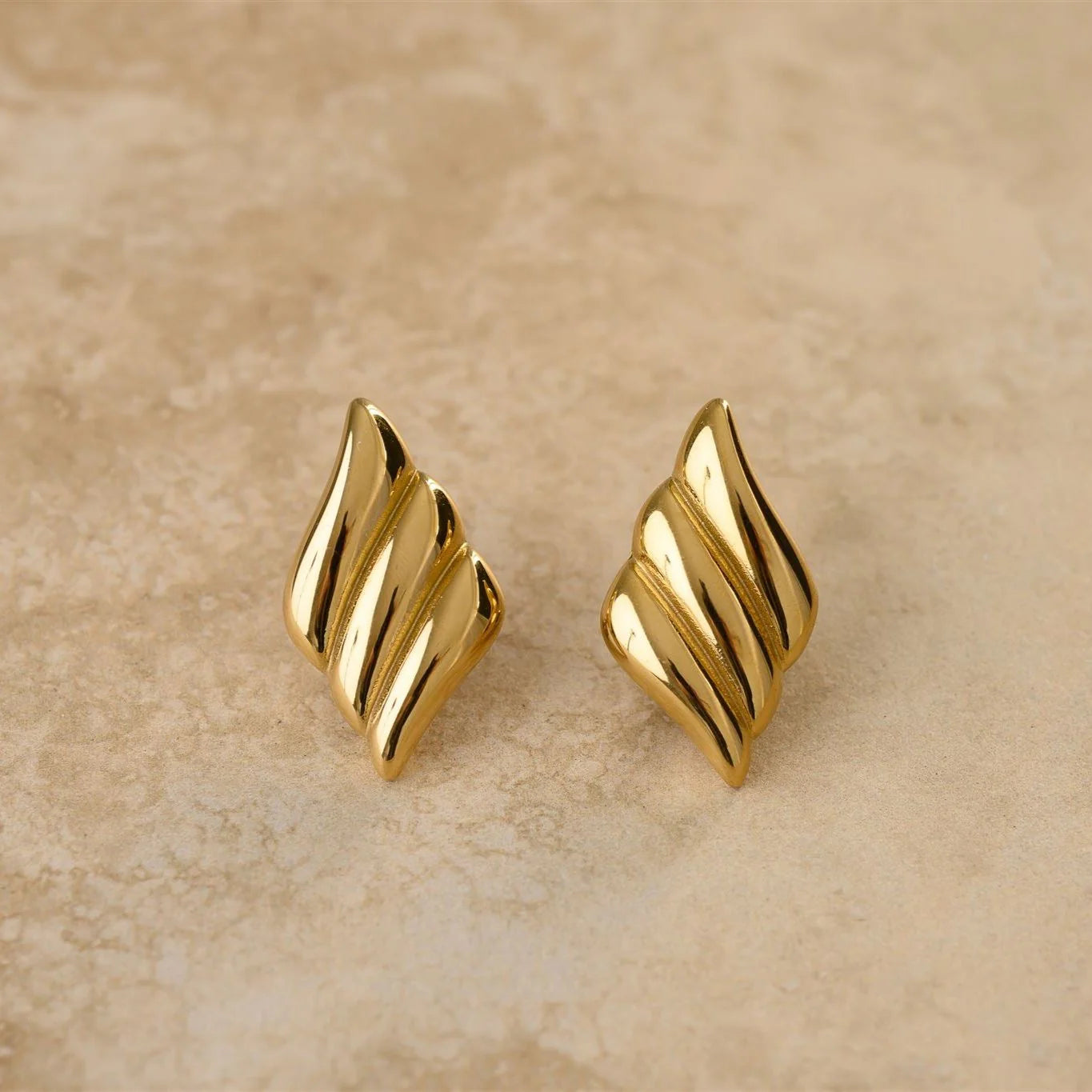Unleash the storm with these diamond-shaped button earrings. Add some sophistication to your outfit and let your inner spark shine through.&nbsp;

18Kt Gold Plated
Shell Shaped/Drop Earrings
Lead, Nickel &amp; Tarnish Free
Hypoallergenic
Measures 3.7cm in length &amp; 2cm in width
Weighs 12g