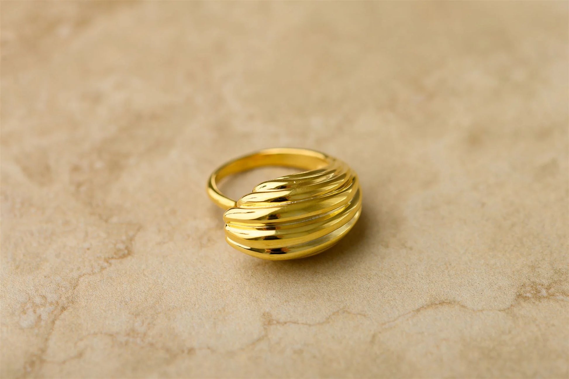 Unleash your bold and playful side with the Elodie Ring. This statement ring features a unique textured design and a curved shape, making it a fun and eye-catching addition to any outfit. Elevate your style game with the Elodie Ring. Pair it with the Elodie earrings.

925 Gold Plated Sterling Silver&nbsp;
Lead,Nickel &amp; Tarnish Free
Hypoallergenic
Waterproof