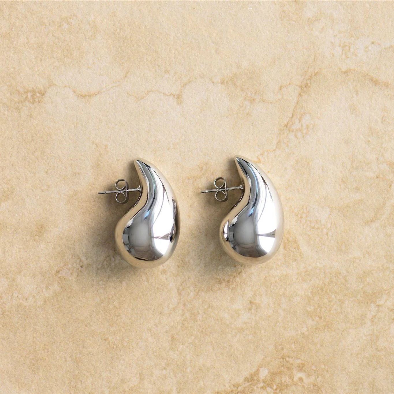 The SOPHIA earrings feature an elegant tear drop design and is available in three sizes, making them perfect for stacking. Crafted from high-quality sterling silver, these earrings are a must-have for any fashion-forward individual.

S925 Gold Plates Sterling Silver
Tear Drop Shaped
Lead,Nickel &amp; Tarnish Free
Hypoallergenic
Available in Silver &amp; Gold

Available in 3 sizes

Small 11mm x18mm
Medium 14mm x 25mm
Large 17mm x 31mm