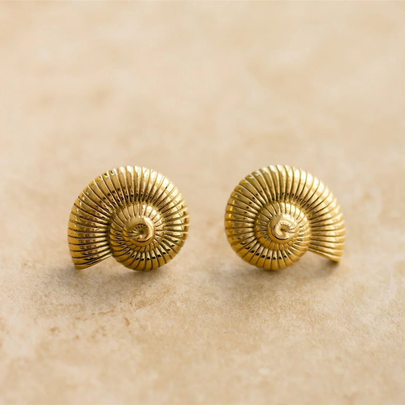 Ride the wave of fashion in our POSEIDON earrings! These shell-shaped beauties are not only trending, but also add a touch of fun to your every day look.

18Kt Gold Plated
Shell Shaped/Drop Earrings
Lead, Nickel & Tarnish Free
Hypoallergenic
