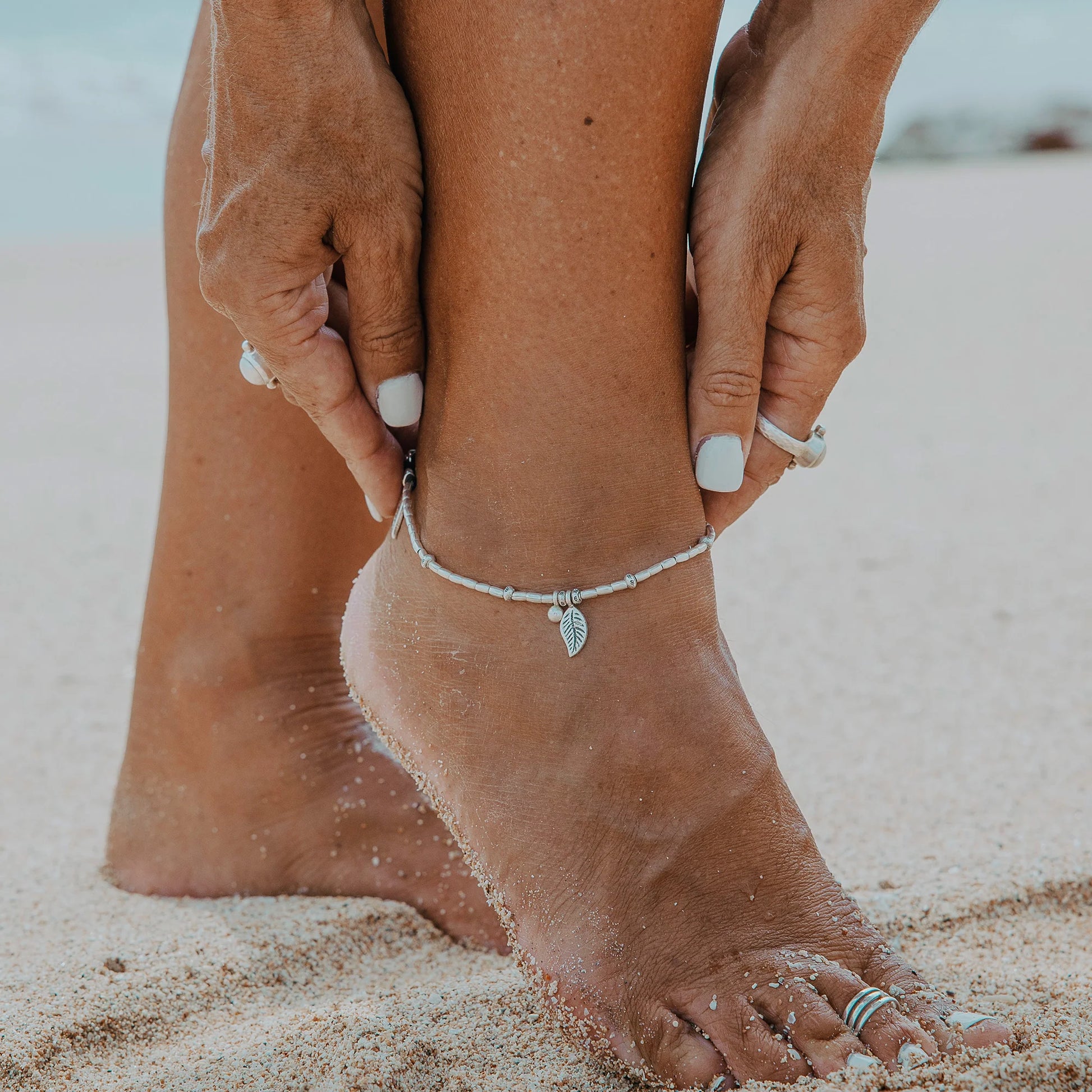 Embark on a dreamy island adventure with our Island Dreaming Anklet. Handcrafted with love, this anklet features Hill Tribe Silver beads and charms that exude bohemian charm and coastal elegance. The Polywax cotton cord adds a touch of natural texture, while the Sterling Silver clasp and adjustable link ensure a secure and comfortable fit. Let the Island Dreaming Anklet be a reminder of carefree days and the beauty of island living.