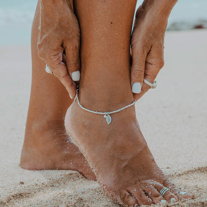 Embark on a dreamy island adventure with our Island Dreaming Anklet. Handcrafted with love, this anklet features Hill Tribe Silver beads and charms that exude bohemian charm and coastal elegance. The Polywax cotton cord adds a touch of natural texture, while the Sterling Silver clasp and adjustable link ensure a secure and comfortable fit. Let the Island Dreaming Anklet be a reminder of carefree days and the beauty of island living.