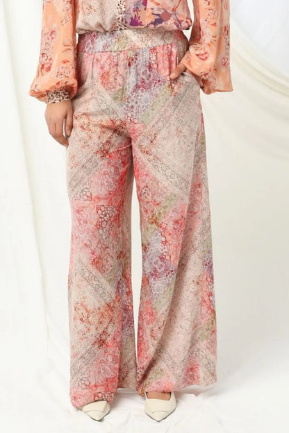 the kachel selena pant in pink is a stylish wide-leg pant in a viscose fabric in a beaituful patchwork print in warm feminine tones