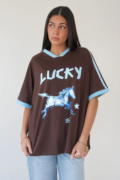 Lucky Horse Oversized T-Shirt Chocolate &amp; Blue is a statement everyday tee featuring a bold lucky horse graphic across the bust and a relaxed boxy oversized fit. 