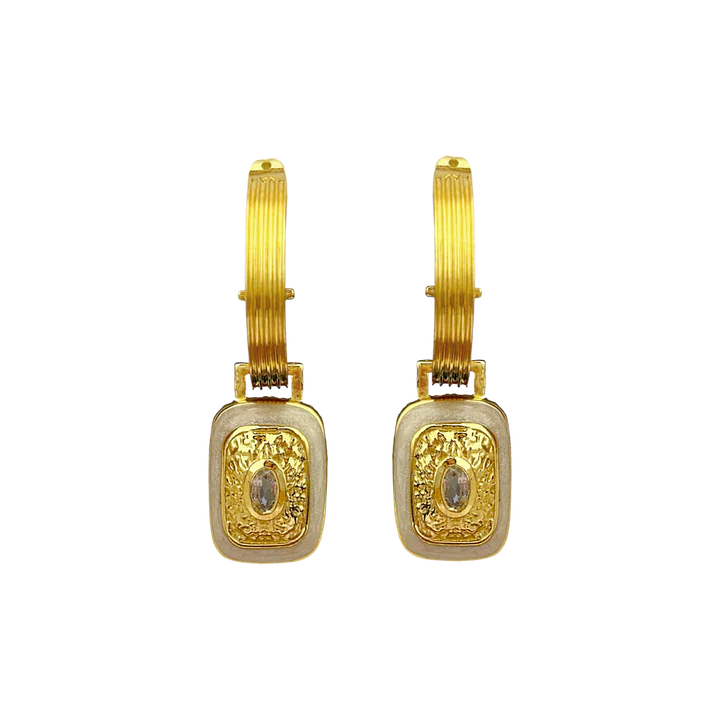 The&nbsp;Mara's are the epitome of classic style with a fabulous yet playful twist.&nbsp;They're beautiful, chic, and oh-so sassy… Crafted on a chunky fluted hoop, they feature a unique rectangle motif drop, combine with hammered gold texture,&nbsp;pearlescent enamel&nbsp;and eye-catching&nbsp;faceted Crystal Quartz&nbsp;gemstones. The Mara Earrings&nbsp;can be worn from day to night, with dazzling yet sophisticated flair that’s sure to turn heads. Enjoy the perfect balance of classic yet flirty with these 