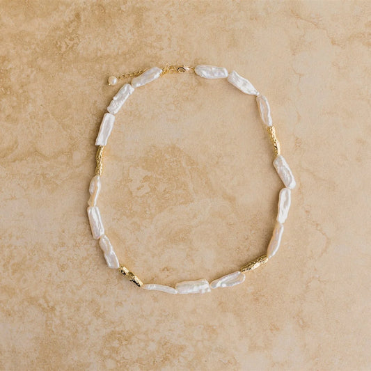 Add a touch of luxury to your look with the MALAKAI Necklace. This high end baroque pearl necklace is pure elegance, making it a must-have accessory. 

18Kt Gold Vermeil
Crushed Gold/Pure Baroque Pearl
Lead,Nickel & Tarnish Free
Hypoallergenic
Measures 40cm + 6cm in length
Weighs 24.9g