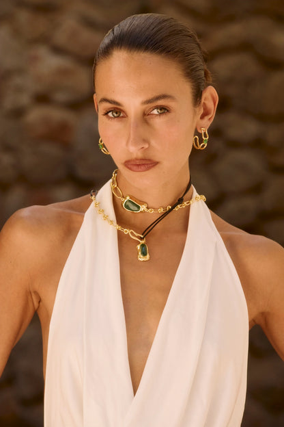 The Sascha Earrings bring sculptural sophistication to your everyday rotation.
An organic,open double-hoop silhouette, anchored by a vibrant Green Jade gemstone at its center - an unexpected focal point that feels both grounded and playful. Softly textured gold catches the light, adding dimension and a subtle vintage-inspired edge.