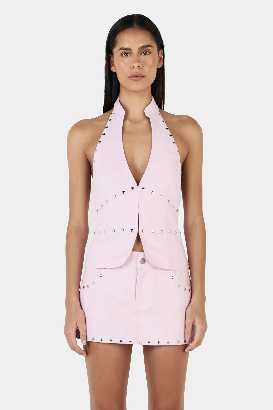 Make a Statement, Turn Every Head

Step out in the Selma Studded Top, Ownley’s bold halter vest designed for maximum impact. Featuring a plunging neckline, silver stud detailing, and a sleek backless design, this structured top adds an edgy, fashion-forward edge to any outfit. The hook-and-eye closure at the center front keeps it secure, while its versatile style lets you rock it solo or pair it with the matching Nikita Studded Skort for a head-turning, coordinated look.