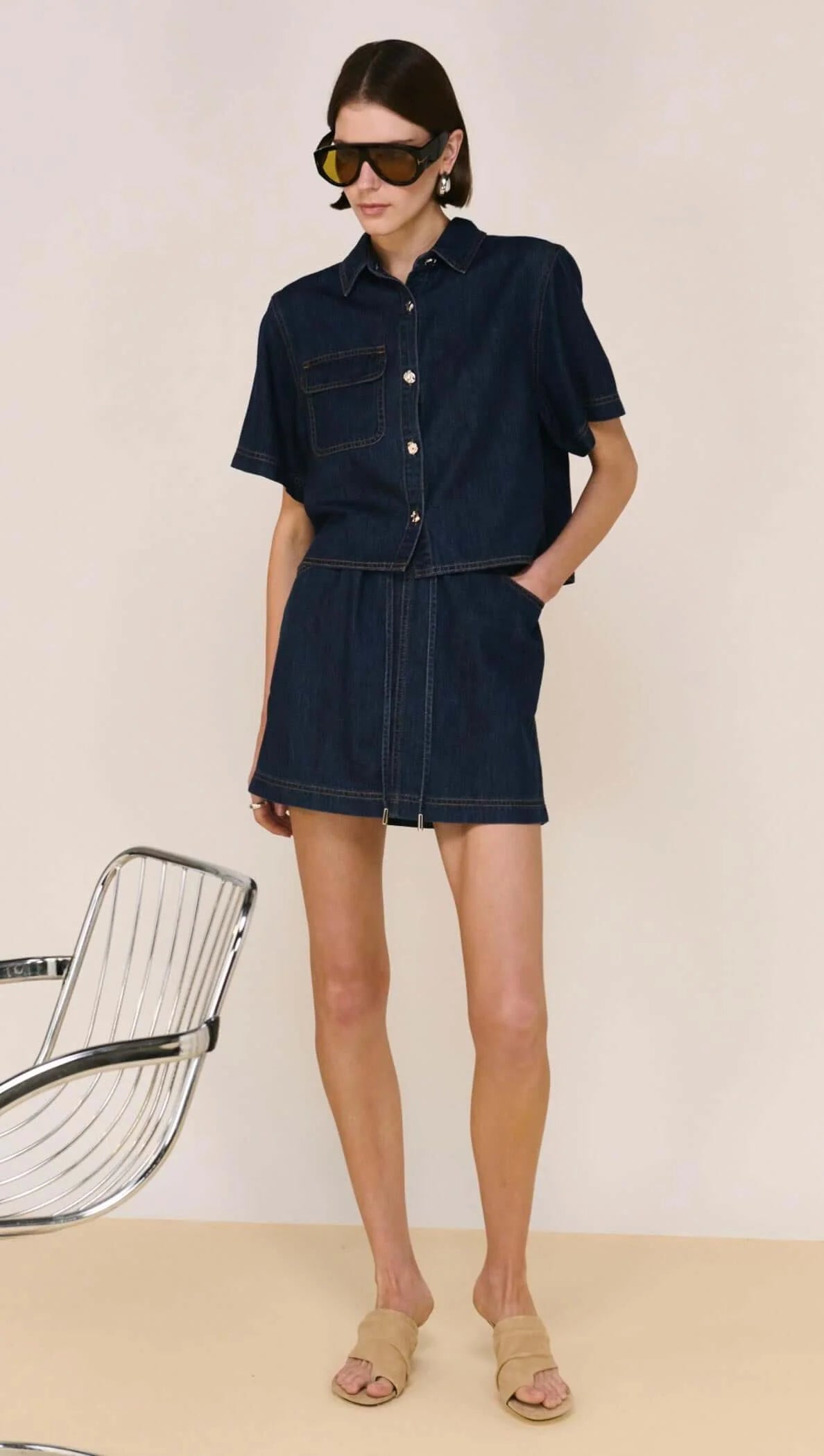 The Lea Denim Cropped Short-Sleeve Shirt is a modern take on classic denim, designed with a structured cropped silhouette and clean, tailored lines. Crafted from a soft cotton and lyocell blend, it offers a comfortable, lightweight feel while maintaining a polished finish - perfect for elevated everyday styling.

