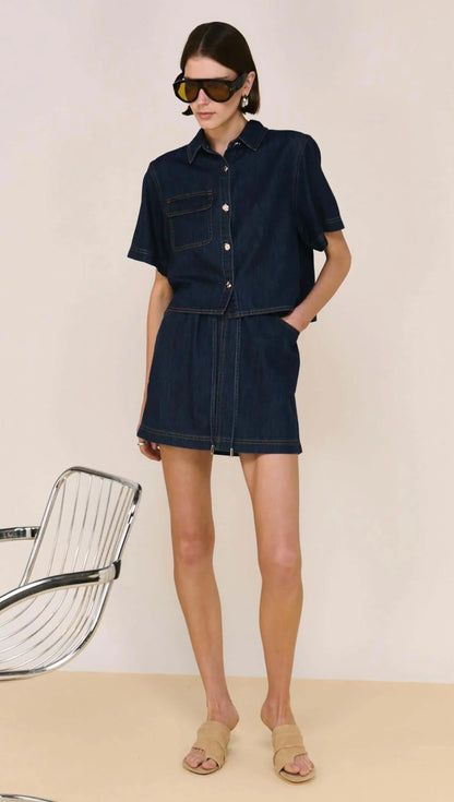 The Lea Denim Cropped Short-Sleeve Shirt is a modern take on classic denim, designed with a structured cropped silhouette and clean, tailored lines. Crafted from a soft cotton and lyocell blend, it offers a comfortable, lightweight feel while maintaining a polished finish - perfect for elevated everyday styling.
