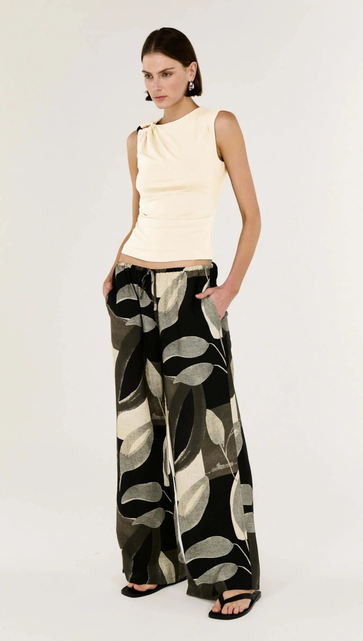 Sleek, Subtle, Statement-Making.

The Blair Cream Ruched Slinky Tank from Staple The Label is your go-to for effortless everyday polish with a modern twist. Crafted from soft stretch jersey, this sleeveless tank skims the body with a fitted silhouette, while subtle ruching adds texture and movement. The standout metal hardware at the shoulder gives it a chic, sculptural edge that elevates any outfit.
