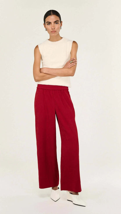 The Echo Red Silky Wide Leg Pant is a statement staple designed with a fluid drape and relaxed tailoring for elevated everyday wear. Crafted from a soft, lightweight fabrication, it features a comfortable elasticated waistband and wide leg silhouette, finished with contrast side stripe detailing for a modern, sporty edge.