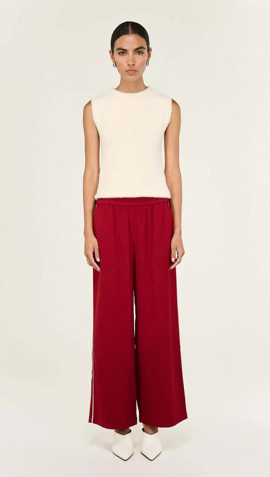 The Echo Red Silky Wide Leg Pant is a statement staple designed with a fluid drape and relaxed tailoring for elevated everyday wear. Crafted from a soft, lightweight fabrication, it features a comfortable elasticated waistband and wide leg silhouette, finished with contrast side stripe detailing for a modern, sporty edge.
