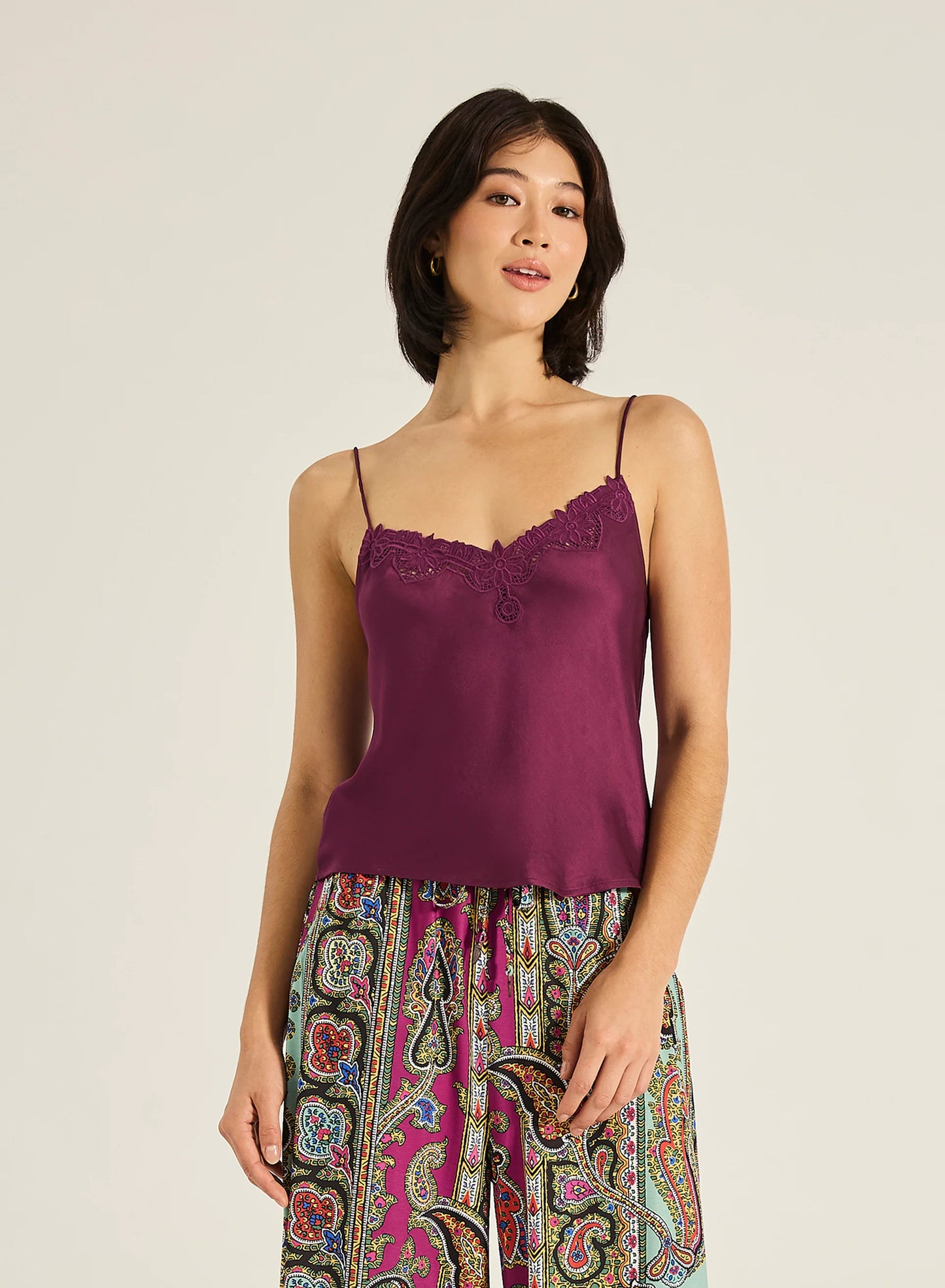 Meet the Kit Cami—an effortlessly elegant piece crafted with a soft V neckline, adjustable straps, and intricate embroidered detailing. Designed to drape beautifully with a luxurious hand feel, it brings a touch of timeless sophistication to any outfit. Pair with shorts or a floaty skirt for an ensemble that works from day to night.