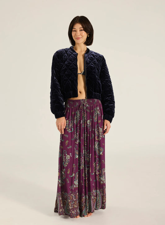 Paraiso Malina Maxi Skirt - Wine
Tigerlily

Step into effortless elegance with the Malina Maxi Skirt. Crafted from a luxe viscose fabrication with subtle gold lurex stripe detailing, it features a comfortable shirred waistband and a self-tie finished with gold bead accents. A timeless addition to your wardrobe, this piece makes a refined yet striking impression.