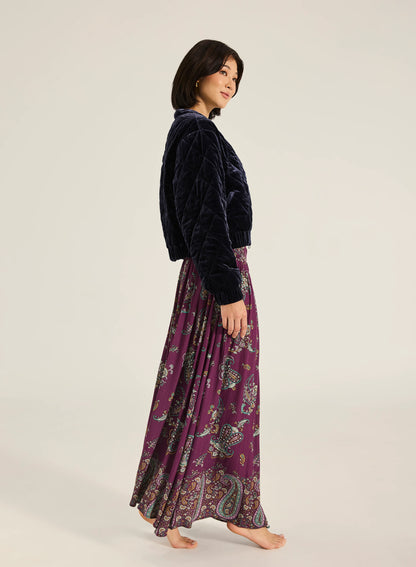 Paraiso Malina Maxi Skirt - Wine
Tigerlily

Step into effortless elegance with the Malina Maxi Skirt. Crafted from a luxe viscose fabrication with subtle gold lurex stripe detailing, it features a comfortable shirred waistband and a self-tie finished with gold bead accents. A timeless addition to your wardrobe, this piece makes a refined yet striking impression.