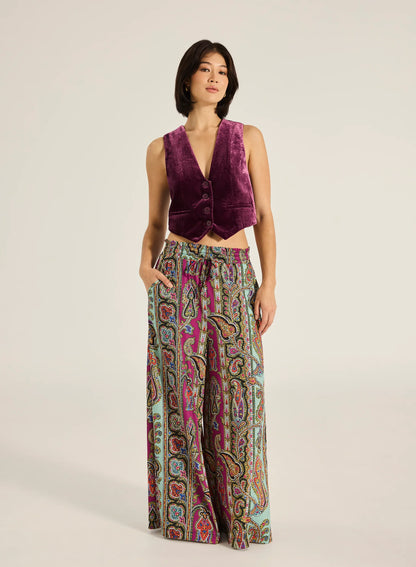 Step into style with the Valentina Pant, a wide- leg palazzo design featuring a charming ruffle edge and a drawstring finish. With convenient side slash pockets, these versatile pants can be worn as a statement style or as luxe over- swim.
