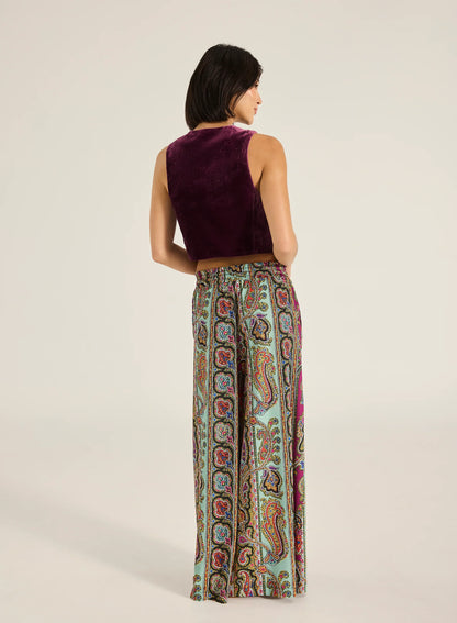 Step into style with the Valentina Pant, a wide- leg palazzo design featuring a charming ruffle edge and a drawstring finish. With convenient side slash pockets, these versatile pants can be worn as a statement style or as luxe over- swim.