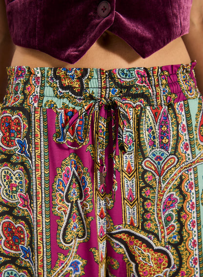 Step into style with the Valentina Pant, a wide- leg palazzo design featuring a charming ruffle edge and a drawstring finish. With convenient side slash pockets, these versatile pants can be worn as a statement style or as luxe over- swim.