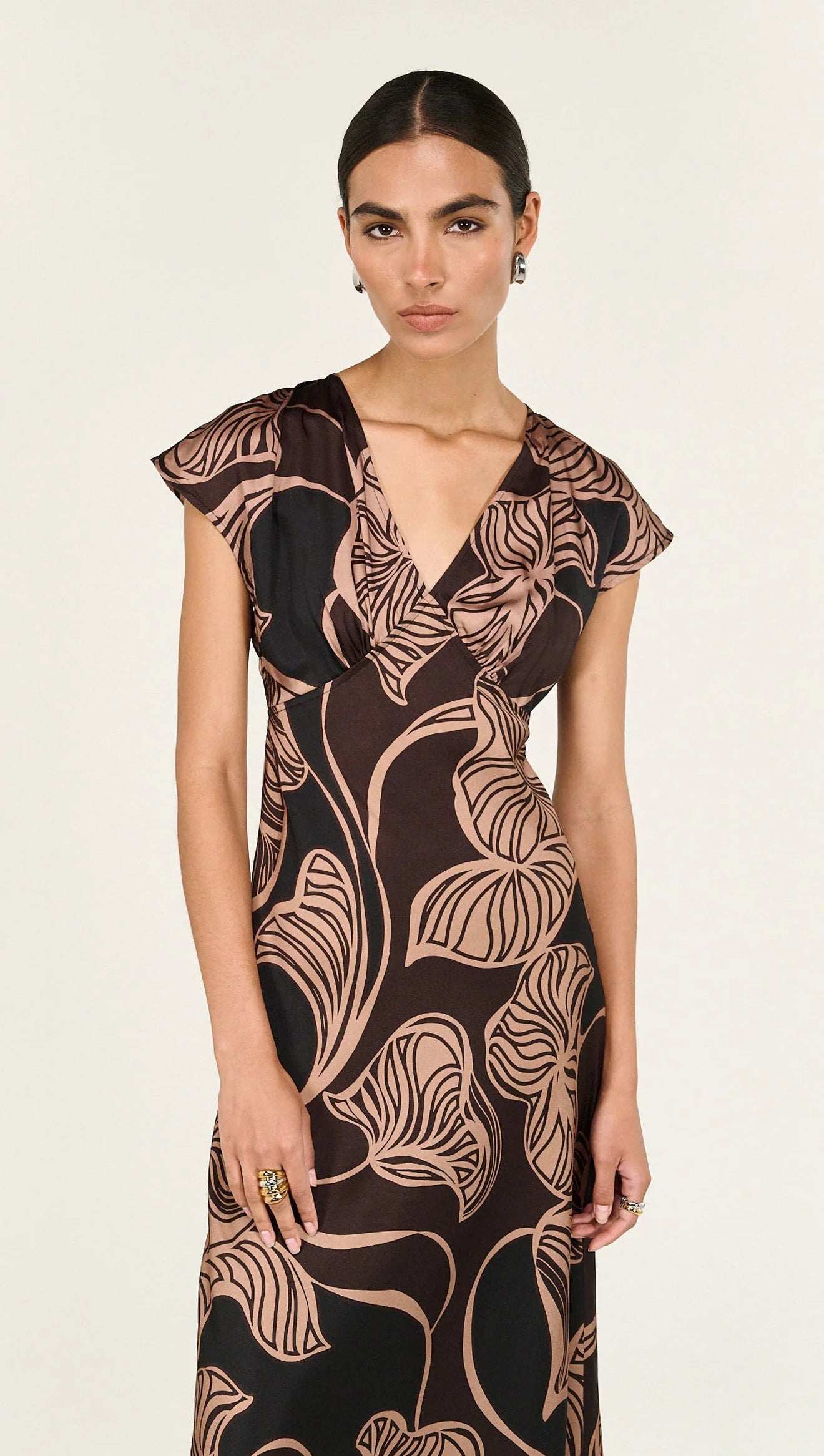 The Abstract Leaf Print Bias Cut Midi Dress is designed to bring effortless elegance to occasion dressing. Cut on the bias, this style drapes beautifully over the body, creating a flattering, fluid silhouette. 