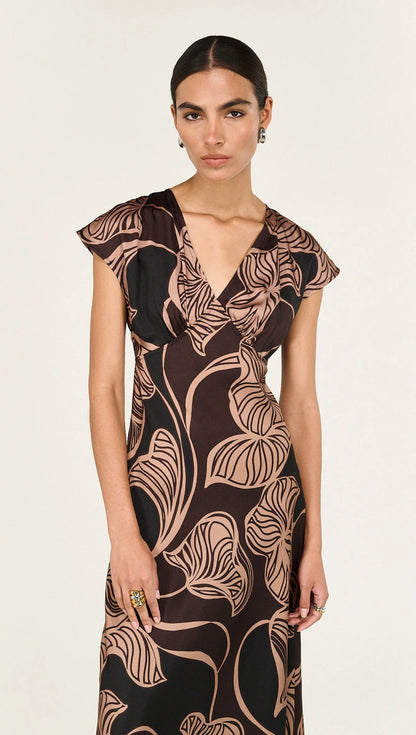 The Abstract Leaf Print Bias Cut Midi Dress is designed to bring effortless elegance to occasion dressing. Cut on the bias, this style drapes beautifully over the body, creating a flattering, fluid silhouette. 