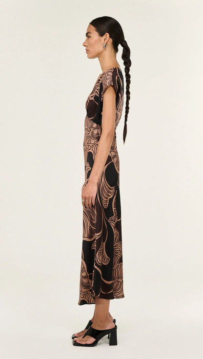 The Abstract Leaf Print Bias Cut Midi Dress is designed to bring effortless elegance to occasion dressing. Cut on the bias, this style drapes beautifully over the body, creating a flattering, fluid silhouette. 