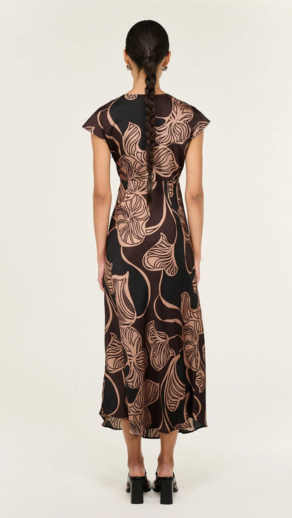The Abstract Leaf Print Bias Cut Midi Dress is designed to bring effortless elegance to occasion dressing. Cut on the bias, this style drapes beautifully over the body, creating a flattering, fluid silhouette. 
