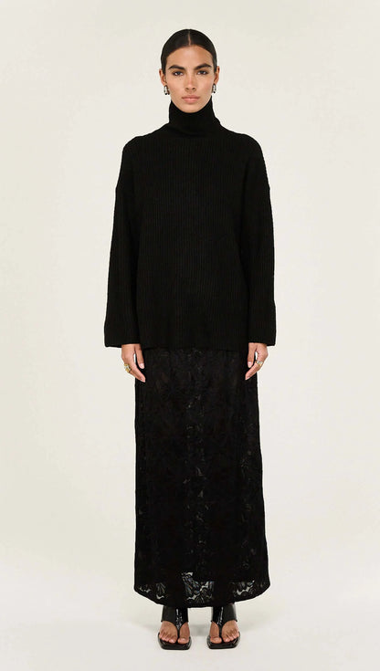 The Black Roll Neck Oversized Knit Jumper is a cosy cold-weather essential designed with relaxed proportions and tactile ribbed texture for effortless layering